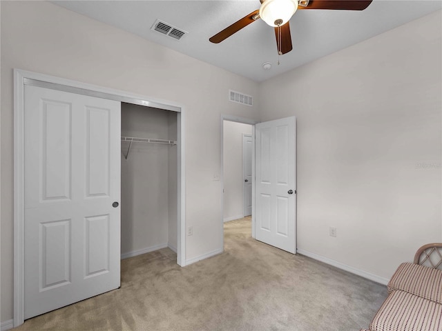 8814 Tuscany Isles Dr, Punta Gorda, FL 33950 - unfurnished bedroom with light carpet, a closet, and a ceiling fan