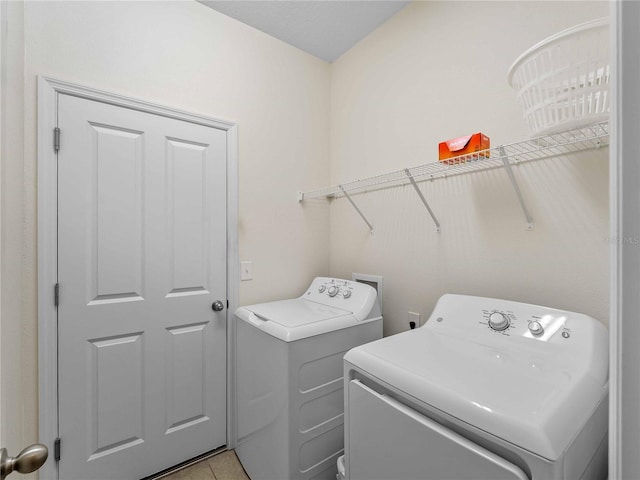 8814 Tuscany Isles Dr, Punta Gorda, FL 33950 - laundry room featuring independent washer and dryer and light tile patterned floors