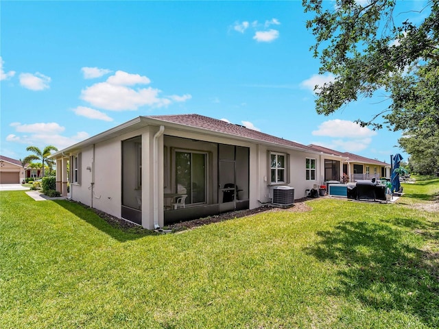 8814 Tuscany Isles Dr, Punta Gorda, FL 33950 - rear view of property with stucco siding, a lawn, and a sunroom