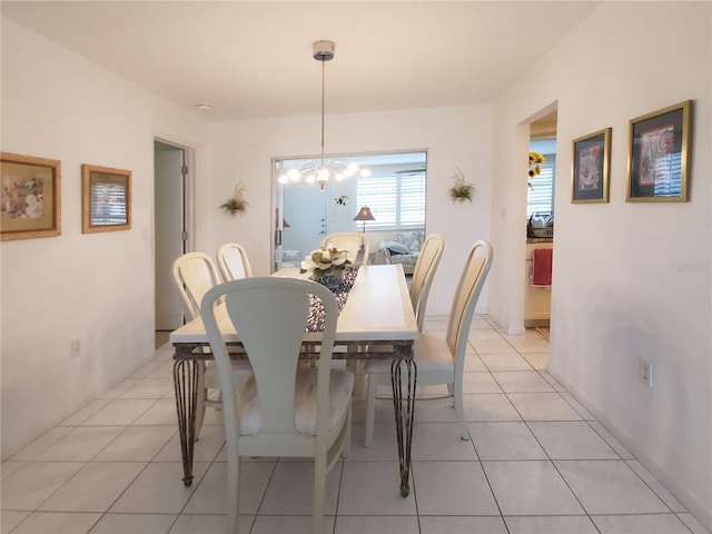 2220 Broad Ranch Dr, Port Charlotte, FL 33948 - dining room with light tile patterned flooring and a chandelier