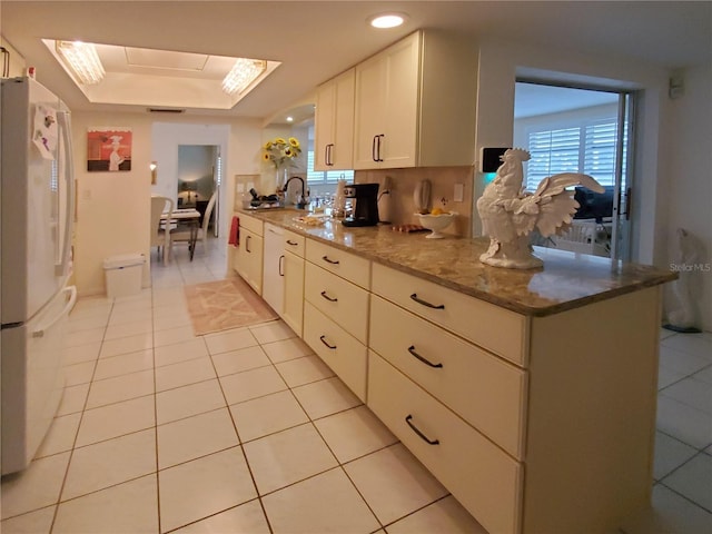2220 Broad Ranch Dr, Port Charlotte, FL 33948 - kitchen featuring white appliances, light stone countertops, light tile patterned flooring, and healthy amount of natural light
