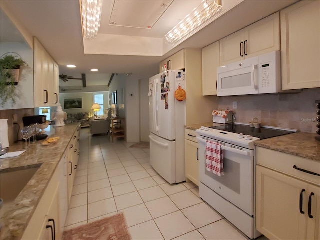 2220 Broad Ranch Dr, Port Charlotte, FL 33948 - kitchen with white appliances, light tile patterned floors, white cabinets, open floor plan, and light stone counters