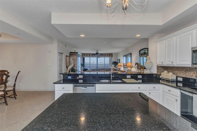 900 E Marion Ave Unit 1403, Punta Gorda, FL 33950 - kitchen with open floor plan, appliances with stainless steel finishes, a chandelier, white cabinetry, and backsplash