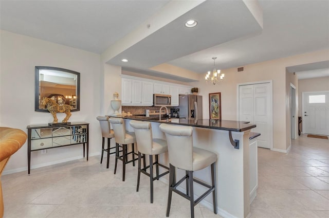 900 E Marion Ave Unit 1403, Punta Gorda, FL 33950 - kitchen featuring stainless steel appliances, a chandelier, a breakfast bar area, dark countertops, and recessed lighting