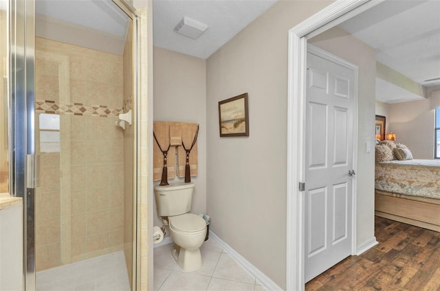 900 E Marion Ave Unit 1403, Punta Gorda, FL 33950 - bathroom with connected bathroom, a stall shower, and wood finished floors