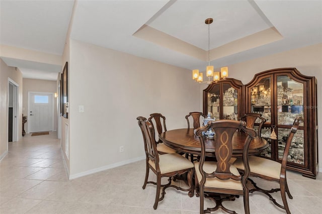 900 E Marion Ave Unit 1403, Punta Gorda, FL 33950 - dining area featuring a chandelier, light tile patterned flooring, and a tray ceiling