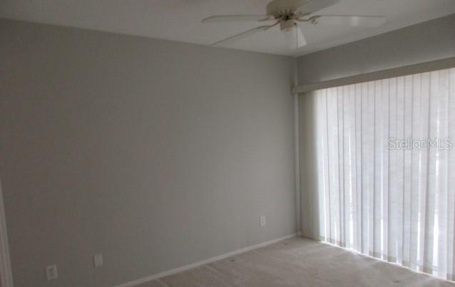 429 Cerromar Ln Unit 353, Venice, FL 34293 - unfurnished room featuring ceiling fan and light colored carpet