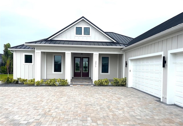 2073 Treasure Ln, Punta Gorda, FL 33982 - modern inspired farmhouse featuring a standing seam roof, french doors, board and batten siding, and a metal roof