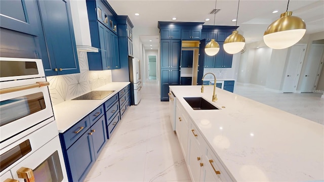 2073 Treasure Ln, Punta Gorda, FL 33982 - kitchen with white appliances, blue cabinetry, recessed lighting, decorative backsplash, and decorative light fixtures