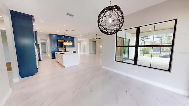 2073 Treasure Ln, Punta Gorda, FL 33982 - kitchen featuring ceiling fan, open floor plan, pendant lighting, light marble finish floors, and recessed lighting
