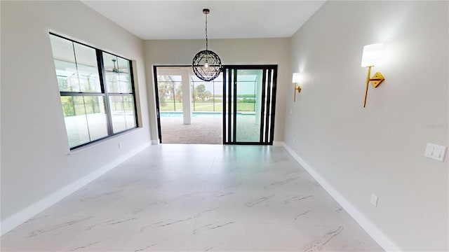 2073 Treasure Ln, Punta Gorda, FL 33982 - unfurnished dining area with a chandelier and marble finish flooring