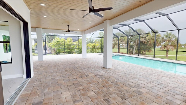 2073 Treasure Ln, Punta Gorda, FL 33982 - view of swimming pool featuring ceiling fan, a patio area, a pool with connected hot tub, and glass enclosure