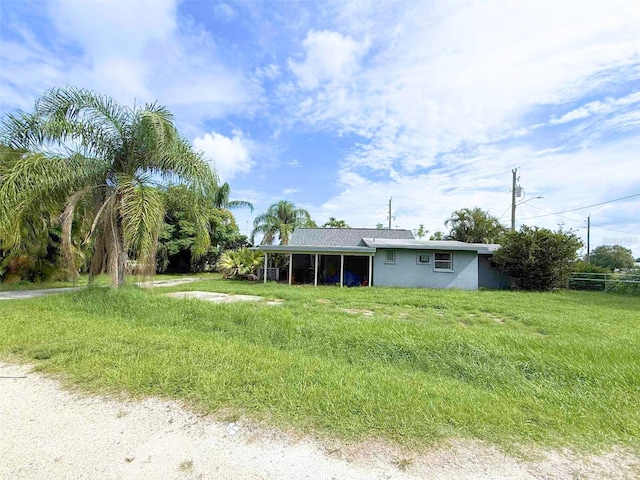 1426 Gary St, Punta Gorda, FL 33982 - rear view of property with a lawn, stucco siding, and an attached carport