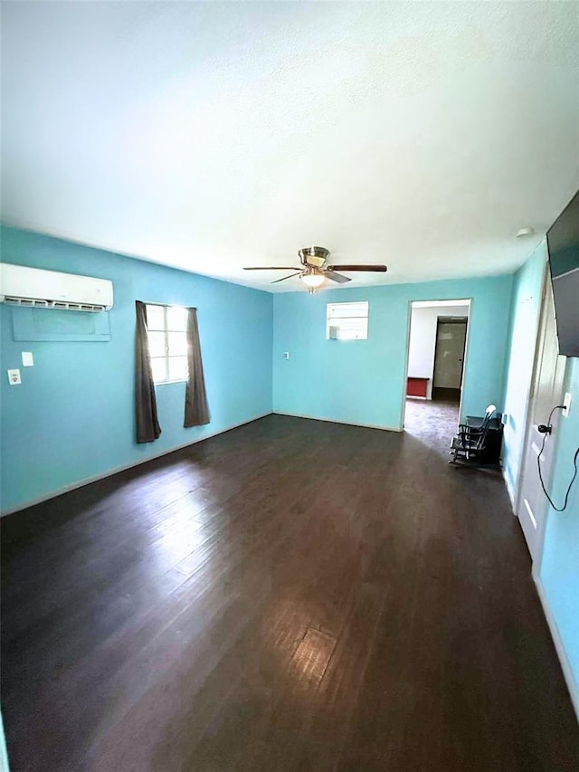 1426 Gary St, Punta Gorda, FL 33982 - unfurnished room with dark wood finished floors, a wall mounted AC, ceiling fan, and a textured ceiling