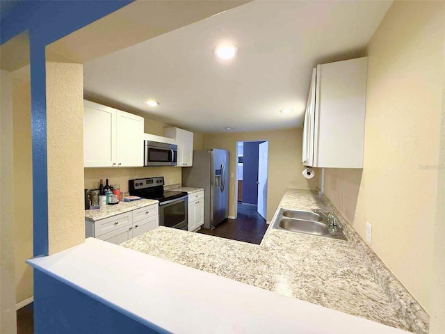 1426 Gary St, Punta Gorda, FL 33982 - kitchen with stainless steel appliances, white cabinetry, recessed lighting, light countertops, and a peninsula