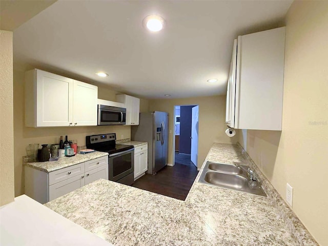 1426 Gary St, Punta Gorda, FL 33982 - kitchen featuring appliances with stainless steel finishes, white cabinets, light countertops, recessed lighting, and dark wood-type flooring