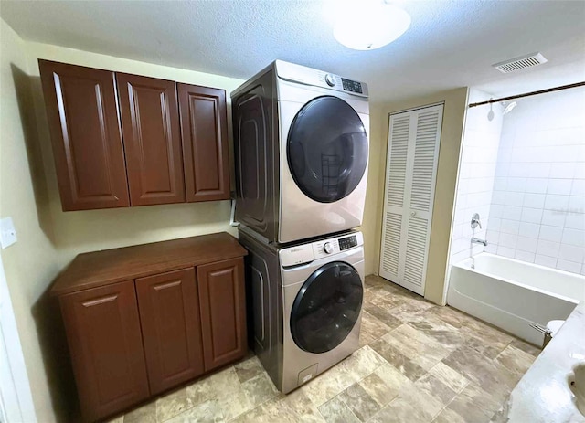 1426 Gary St, Punta Gorda, FL 33982 - laundry area featuring stacked washing machine and dryer and cabinet space