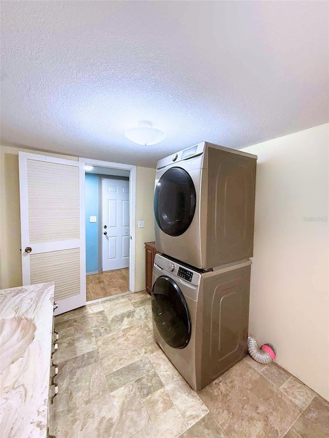 1426 Gary St, Punta Gorda, FL 33982 - washroom featuring estacked washer and dryer and a textured ceiling