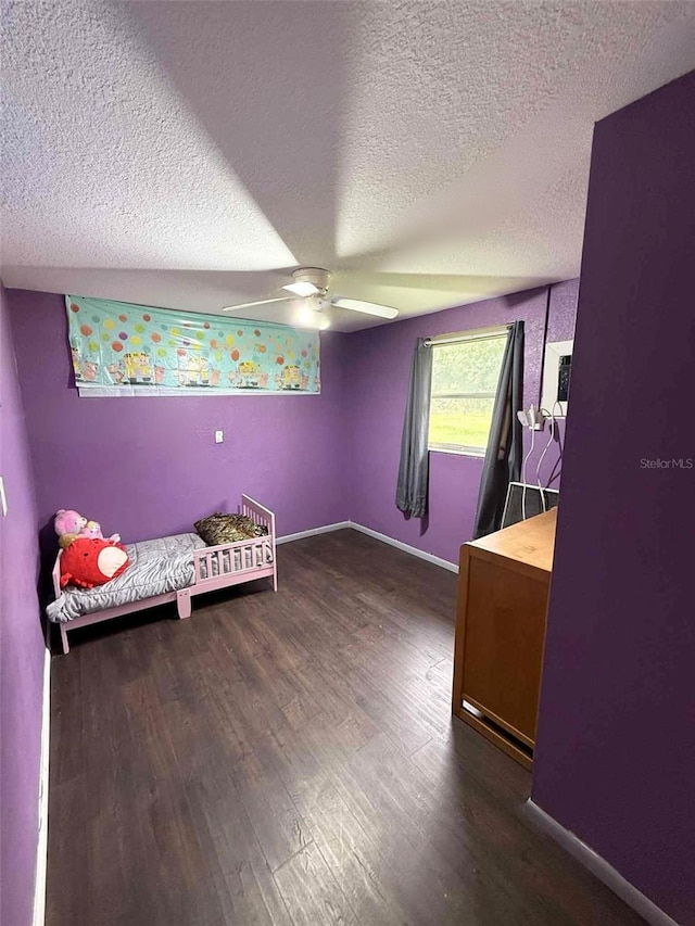 1426 Gary St, Punta Gorda, FL 33982 - unfurnished bedroom featuring a textured ceiling, wood finished floors, and ceiling fan