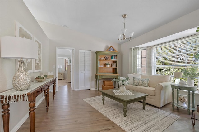 2474 Rio De Janeiro Ave, Punta Gorda, FL 33983 - living room featuring lofted ceiling, a chandelier, and light wood-style floors