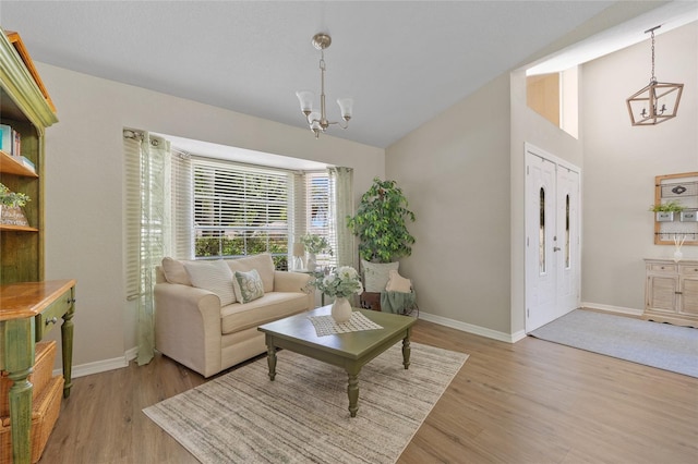 2474 Rio De Janeiro Ave, Punta Gorda, FL 33983 - living room with a chandelier, wood finished floors, and high vaulted ceiling