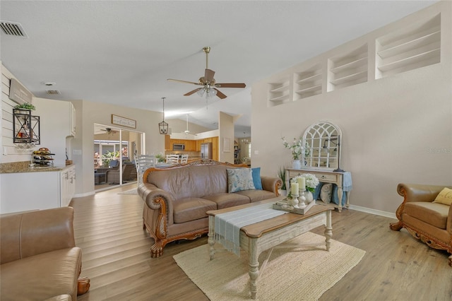 2474 Rio De Janeiro Ave, Punta Gorda, FL 33983 - living room featuring ceiling fan, vaulted ceiling, and light wood-style floors