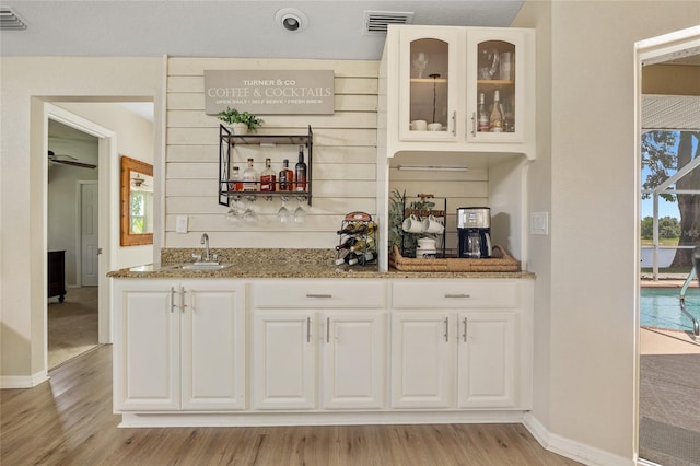 2474 Rio De Janeiro Ave, Punta Gorda, FL 33983 - indoor wet bar featuring light wood-style flooring and plenty of natural light