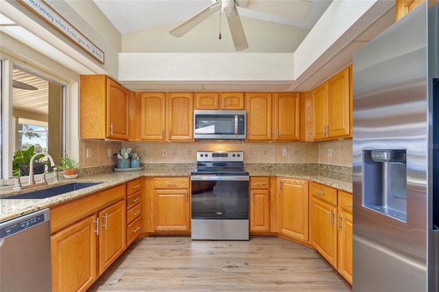 2474 Rio De Janeiro Ave, Punta Gorda, FL 33983 - kitchen featuring stainless steel appliances, light stone counters, light wood finished floors, and ceiling fan