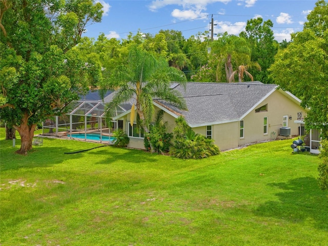 2474 Rio De Janeiro Ave, Punta Gorda, FL 33983 - view of green lawn featuring a lanai and an outdoor pool