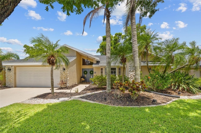 2474 Rio De Janeiro Ave, Punta Gorda, FL 33983 - view of front of home featuring stucco siding, an attached garage, a front yard, and concrete driveway
