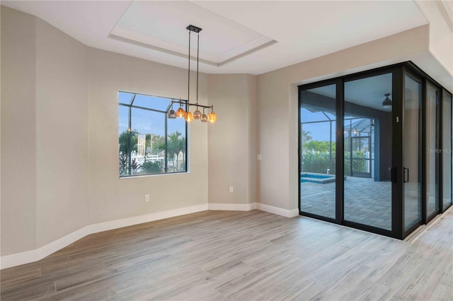 4026 Vasco St, Punta Gorda, FL 33950 - spare room with healthy amount of natural light, light wood-style floors, and a chandelier
