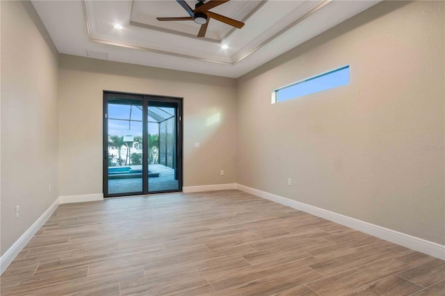 4026 Vasco St, Punta Gorda, FL 33950 - unfurnished room with a raised ceiling, ceiling fan, light wood-style flooring, and a sunroom