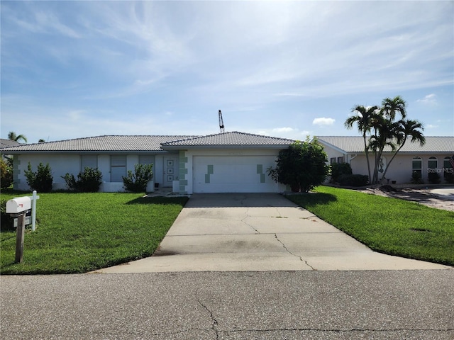 110 Hibiscus Dr, Punta Gorda, FL 33950 - ranch-style house with a tiled roof, concrete driveway, a garage, a front yard, and stucco siding