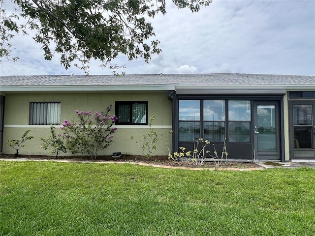 25225 Rampart Blvd Unit 502, Punta Gorda, FL 33983 - view of front of home with a front yard, roof with shingles, and stucco siding