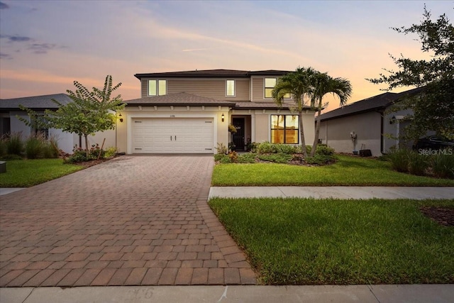2596 Buckthorn Loop, North Port, FL 34289 - view of front of home featuring decorative driveway, a garage, and a front yard