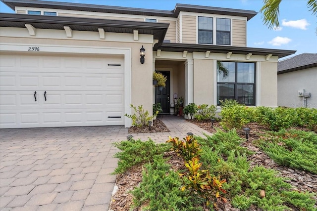 2596 Buckthorn Loop, North Port, FL 34289 - view of front of property with decorative driveway and stucco siding