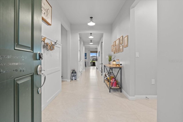 2596 Buckthorn Loop, North Port, FL 34289 - corridor featuring light tile patterned flooring and baseboards