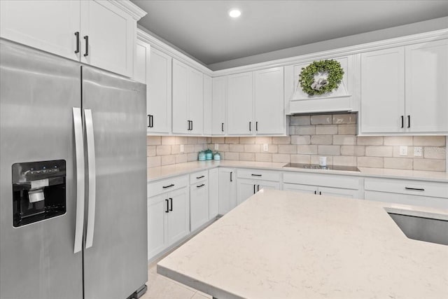 2596 Buckthorn Loop, North Port, FL 34289 - kitchen featuring stainless steel fridge, black electric cooktop, white cabinets, light stone countertops, and recessed lighting