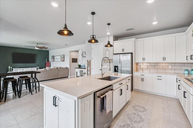 2596 Buckthorn Loop, North Port, FL 34289 - kitchen with appliances with stainless steel finishes, ceiling fan, light countertops, pendant lighting, and tasteful backsplash
