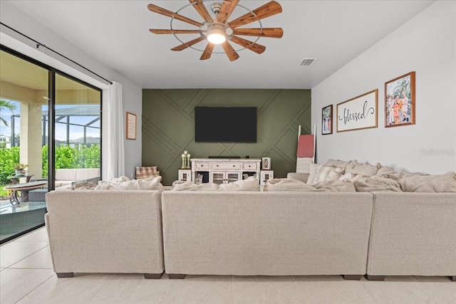 2596 Buckthorn Loop, North Port, FL 34289 - living area featuring ceiling fan, a decorative wall, and light tile patterned floors