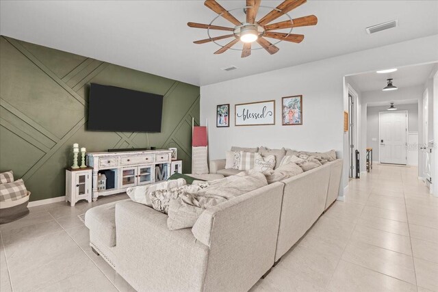 2596 Buckthorn Loop, North Port, FL 34289 - living area with ceiling fan, light tile patterned floors, and a decorative wall