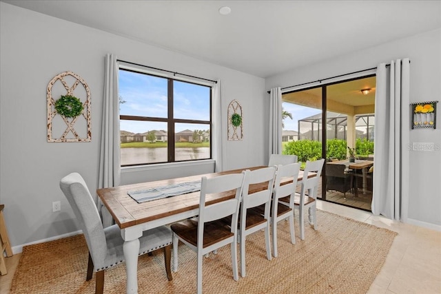 2596 Buckthorn Loop, North Port, FL 34289 - dining room featuring a water view and baseboards