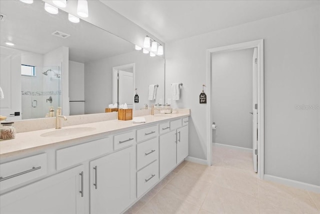 2596 Buckthorn Loop, North Port, FL 34289 - bathroom with double vanity, a shower stall, and tile patterned floors