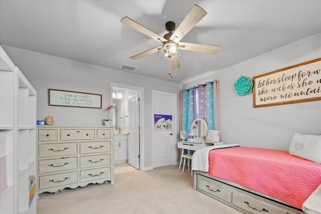 2596 Buckthorn Loop, North Port, FL 34289 - bedroom with light carpet, ensuite bath, and ceiling fan