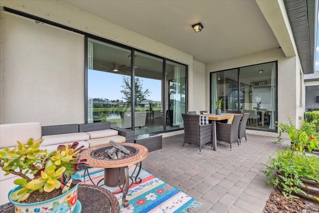 2596 Buckthorn Loop, North Port, FL 34289 - view of patio / terrace featuring an outdoor fire pit, a water view, and outdoor dining area