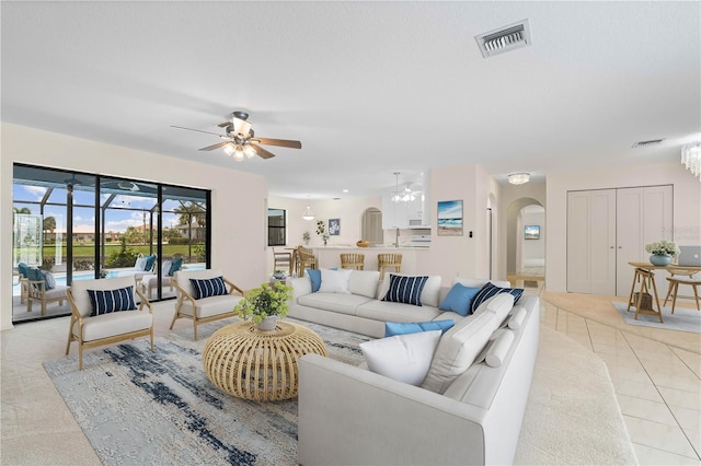 1457 Sea Fan Dr, Punta Gorda, FL 33950 - living room featuring a ceiling fan and arched walkways