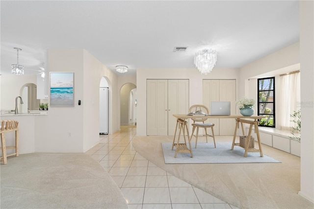 1457 Sea Fan Dr, Punta Gorda, FL 33950 - tiled dining area with arched walkways, a chandelier, and carpet
