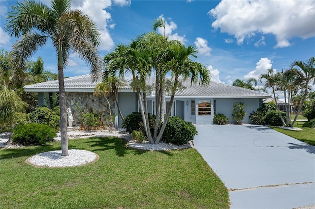 1457 Sea Fan Dr, Punta Gorda, FL 33950 - single story home featuring a tile roof, a front yard, stucco siding, and concrete driveway