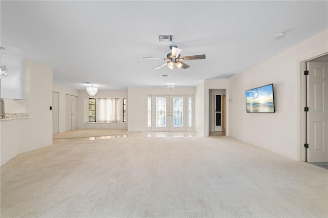 1457 Sea Fan Dr, Punta Gorda, FL 33950 - unfurnished living room with a chandelier, carpet floors, ceiling fan, and french doors