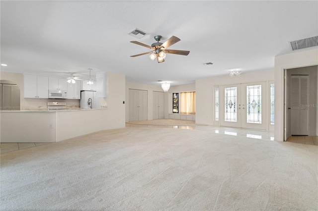 1457 Sea Fan Dr, Punta Gorda, FL 33950 - unfurnished living room with ceiling fan, light colored carpet, and french doors